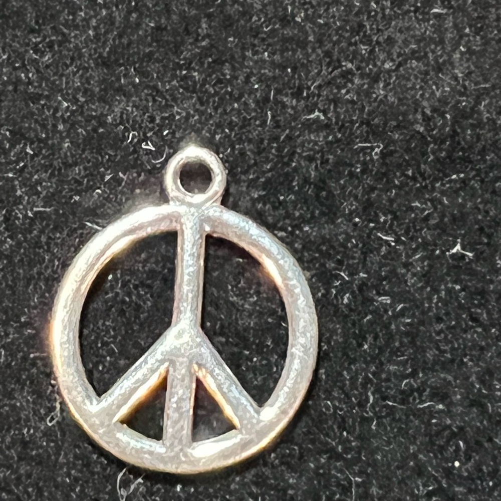 Sterling silver peace sign, I don’t think it’s the retired JA charm